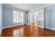 Office space features hardwood floors and large windows, with French doors leading to a hallway at 562 Grassmeade Way, Snellville, GA 30078