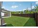 Large backyard with a wood fence and green grass at 1543 Dover Creek Ln, Lawrenceville, GA 30045