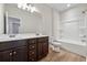 This is a bathroom with a double sink vanity, white cabinets and a tub shower at 1543 Dover Creek Ln, Lawrenceville, GA 30045