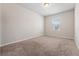 Cozy bedroom with neutral carpeting, a window providing natural light, and fresh paint at 1543 Dover Creek Ln, Lawrenceville, GA 30045