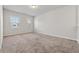 Cozy bedroom featuring neutral carpeting, a window providing natural light, and fresh paint at 1543 Dover Creek Ln, Lawrenceville, GA 30045