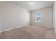 Cozy bedroom with neutral carpeting, a window providing natural light, and fresh paint at 1543 Dover Creek Ln, Lawrenceville, GA 30045