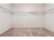 Walk-in closet with wire shelving and neutral carpeting, providing ample storage space at 1543 Dover Creek Ln, Lawrenceville, GA 30045