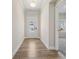 Bright hallway with wood floors and neutral walls, leading to a glimpse of a sunlit room at 1543 Dover Creek Ln, Lawrenceville, GA 30045