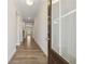 Inviting hallway with wood flooring and natural light streaming through a glass-paneled front door at 1543 Dover Creek Ln, Lawrenceville, GA 30045