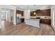 Open kitchen features stainless steel appliances, dark cabinets and a large island with granite countertops at 1543 Dover Creek Ln, Lawrenceville, GA 30045