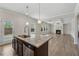 Open kitchen with center island looks into the living room and fireplace with coffered ceilings at 1543 Dover Creek Ln, Lawrenceville, GA 30045