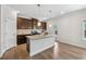 Well-equipped kitchen featuring stainless steel appliances, dark cabinets and a large center island at 1543 Dover Creek Ln, Lawrenceville, GA 30045
