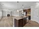 Open kitchen with granite countertops and stainless steel appliances views the adjacent living room with fireplace at 1543 Dover Creek Ln, Lawrenceville, GA 30045