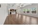 Spacious living room with wood floors, modern lighting, and an open floor plan to the kitchen at 1543 Dover Creek Ln, Lawrenceville, GA 30045