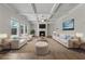 Bright living room with coffered ceilings, fireplace, and large windows providing natural light at 1543 Dover Creek Ln, Lawrenceville, GA 30045
