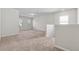 Upstairs loft area with neutral carpeting and plenty of natural light from the windows at 1543 Dover Creek Ln, Lawrenceville, GA 30045