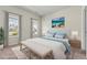 Staged bedroom with neutral walls, modern furnishings, and natural light from nearby windows at 1543 Dover Creek Ln, Lawrenceville, GA 30045