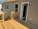 Newly constructed wooden back deck with stairs, exterior access door, and vinyl siding at 202 Gamel Rd, Dallas, GA 30157