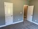 Carpeted bedroom with gray walls and white trim, featuring two paneled doors at 202 Gamel Rd, Dallas, GA 30157