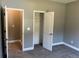 Neutral bedroom features soft carpet, light-gray walls and open closet for optimal storage at 202 Gamel Rd, Dallas, GA 30157