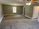 A large bedroom with a ceiling fan, neutral-colored walls, and soft carpet at 202 Gamel Rd, Dallas, GA 30157