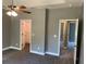 Carpeted bedroom featuring a ceiling fan and multiple doorways at 202 Gamel Rd, Dallas, GA 30157