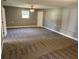 A spacious bedroom has neutral-colored walls, soft carpet, and a ceiling fan at 202 Gamel Rd, Dallas, GA 30157