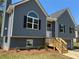 Charming two-story home with a gray exterior, black shutters, and a welcoming front porch at 202 Gamel Rd, Dallas, GA 30157