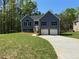 Inviting two-story home with a spacious front yard and a two-car garage at 202 Gamel Rd, Dallas, GA 30157