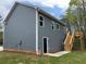 Rear view of home featuring a backyard deck, exterior door and wooded lot at 202 Gamel Rd, Dallas, GA 30157