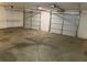Spacious three-car garage with white doors and ample parking area at 202 Gamel Rd, Dallas, GA 30157