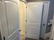 Hallway with three doors, showcasing neutral walls and carpet at 202 Gamel Rd, Dallas, GA 30157
