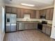 Modern kitchen with stainless steel appliances, granite countertops, and wood floors at 202 Gamel Rd, Dallas, GA 30157