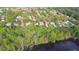 A scenic aerial view showing homes nestled by a peaceful lake and vibrant trees at 290 Magnolia Walk Ln, Atlanta, GA 30349