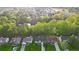 A stunning aerial view showcasing homes with lush trees and a serene pond at 290 Magnolia Walk Ln, Atlanta, GA 30349