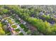 Serene aerial view of a suburban neighborhood, highlighting lush greenery and a tranquil pond at 290 Magnolia Walk Ln, Atlanta, GA 30349