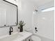 Bathroom features an updated vanity, quartz countertop, black plumbing fixtures, and shower/tub combo at 290 Magnolia Walk Ln, Atlanta, GA 30349