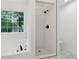 Bright bathroom features a soaking tub and glass enclosed shower with matte black fixtures at 290 Magnolia Walk Ln, Atlanta, GA 30349