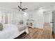 Bright bedroom features a ceiling fan, light wood floors, neutral decor and access to en suite bathroom at 290 Magnolia Walk Ln, Atlanta, GA 30349