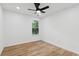 This bedroom features a ceiling fan, light wood floors, and a window view at 290 Magnolia Walk Ln, Atlanta, GA 30349