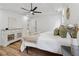Bright bedroom features a ceiling fan, light wood floors, neutral decor and en suite bath access at 290 Magnolia Walk Ln, Atlanta, GA 30349