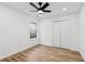 This bedroom offers wood-look floors, a ceiling fan, and a large window at 290 Magnolia Walk Ln, Atlanta, GA 30349
