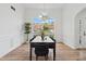 Stylish dining room with hardwood floors, an elegant chandelier, large window views and modern decor at 290 Magnolia Walk Ln, Atlanta, GA 30349