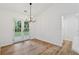 Bright dining room with new chandelier, wood floors, and access to back yard at 290 Magnolia Walk Ln, Atlanta, GA 30349