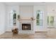 Living room with fireplace, wood flooring, and arched windows with natural light at 290 Magnolia Walk Ln, Atlanta, GA 30349