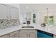 A gorgeous updated kitchen with stainless appliances, backsplash and granite countertops at 290 Magnolia Walk Ln, Atlanta, GA 30349