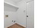 The simple laundry room features wood-look floor, a shelf, and hookups for washer/dryer at 290 Magnolia Walk Ln, Atlanta, GA 30349