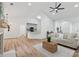 Bright open concept living space featuring hardwood floors, a fireplace, and an adjacent kitchen with a breakfast bar at 290 Magnolia Walk Ln, Atlanta, GA 30349
