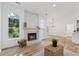 This beautiful living room is highlighted by windows, a fireplace and wood floors at 290 Magnolia Walk Ln, Atlanta, GA 30349