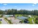 A scenic aerial shot capturing a community pool, tennis courts, clubhouse, pond and other outdoor amenities at 315 Silver Moon Dr, Loganville, GA 30052