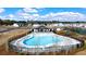 Aerial view of community pool, playground, tennis courts, and clubhouse in a well-maintained community at 315 Silver Moon Dr, Loganville, GA 30052
