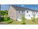 Backyard view with lawn, patio, and exterior of newly constructed townhome at 315 Silver Moon Dr, Loganville, GA 30052