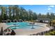 Community pool featuring lounge chairs, umbrellas, and a wading area at 315 Silver Moon Dr, Loganville, GA 30052
