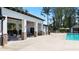 Community pool with grilling area, covered patio, and outdoor dining areas surrounded by tall trees at 315 Silver Moon Dr, Loganville, GA 30052